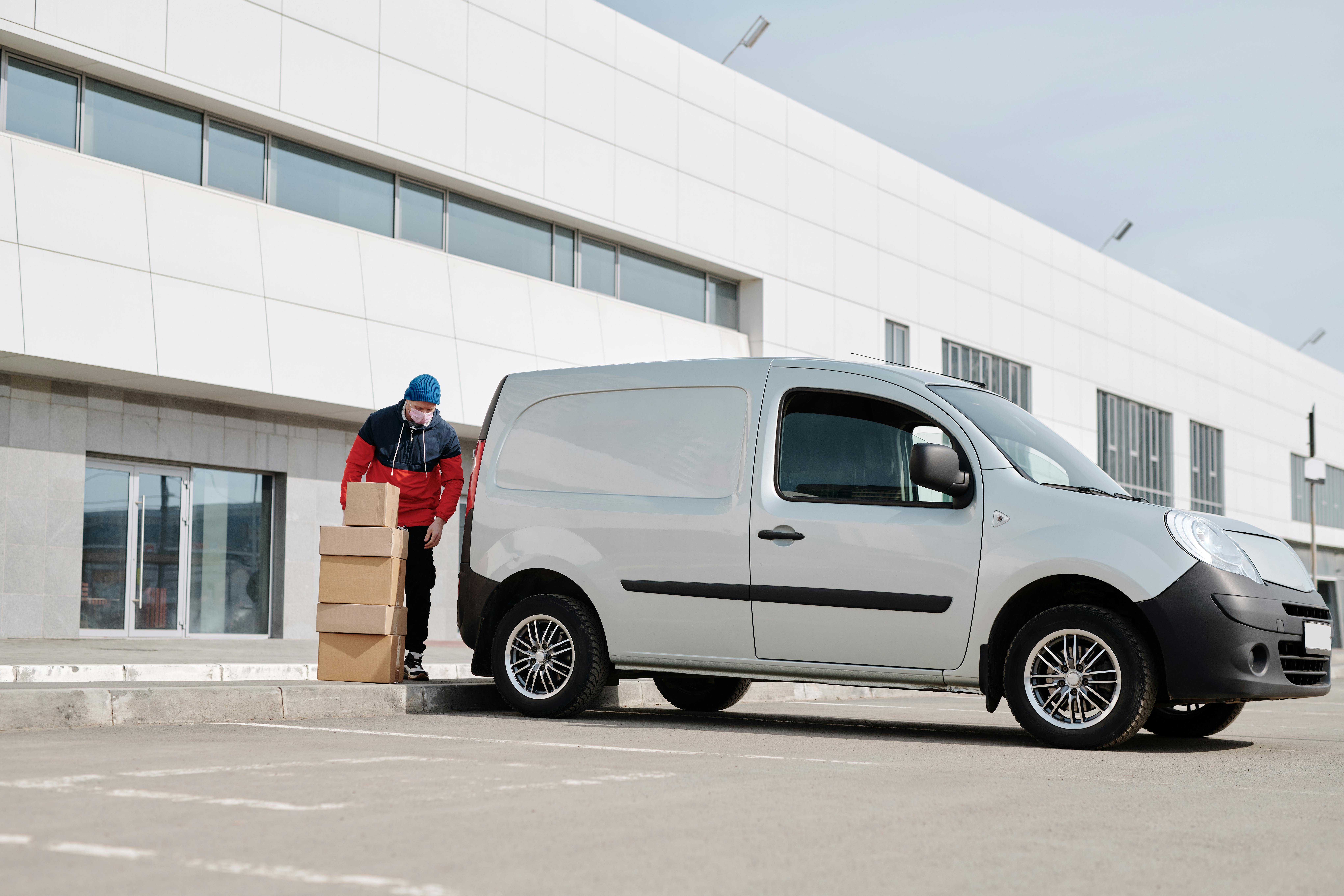 Man with boxes next to a van