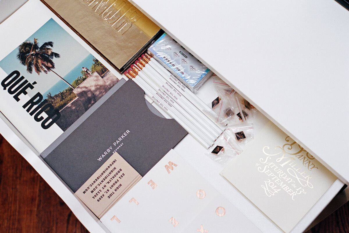 Business cards and logos in a desk drawer - How to Build a Brand: A Guide That Actually Works