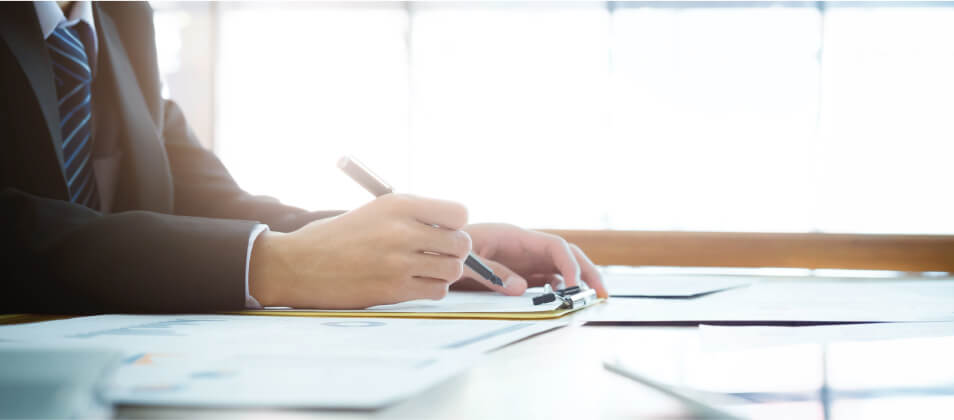 A man filling out an employee agreement - How to Draft an Employment Agreement