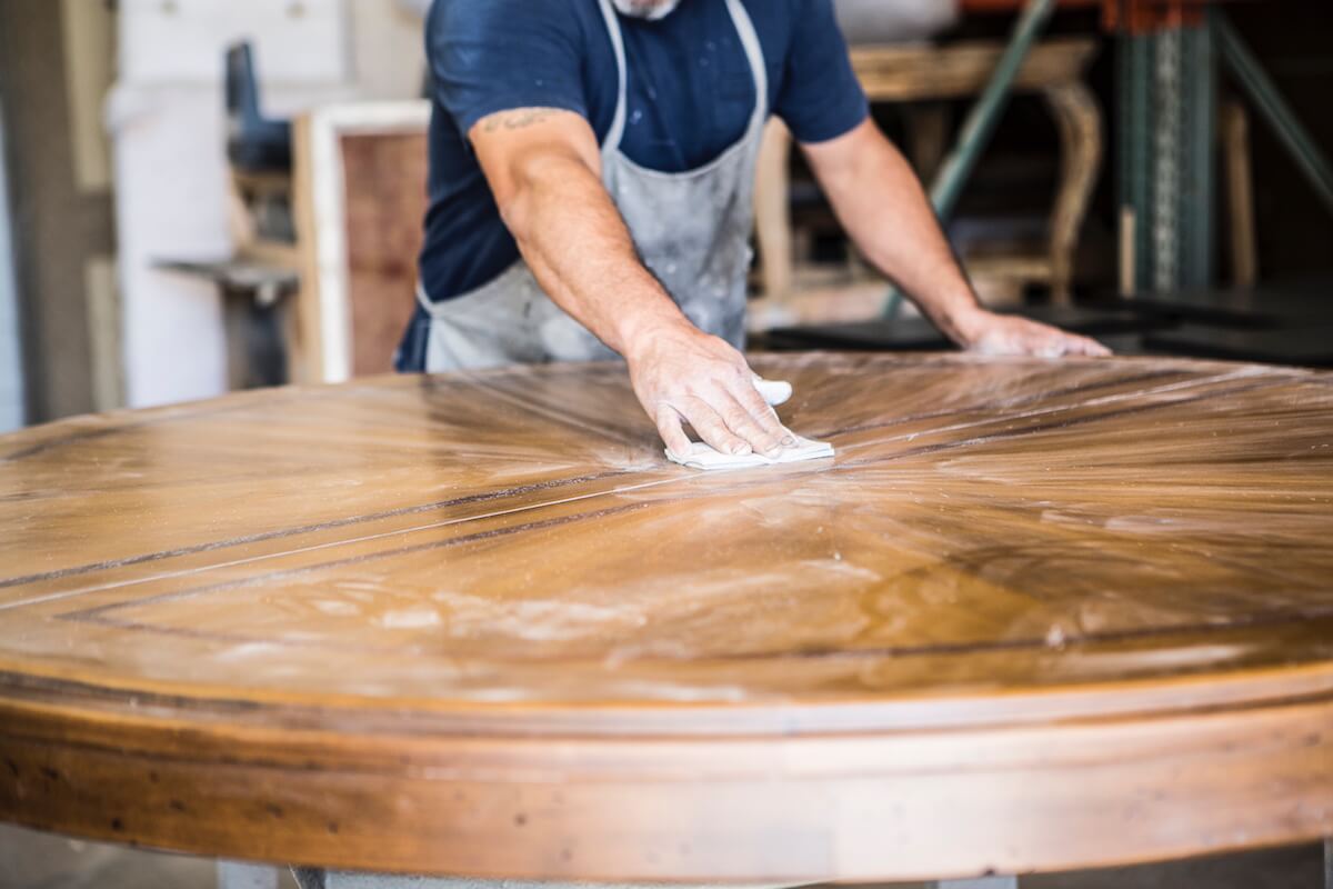 A worker sanding a wooden table - Business Owner's Policy: The Rundown