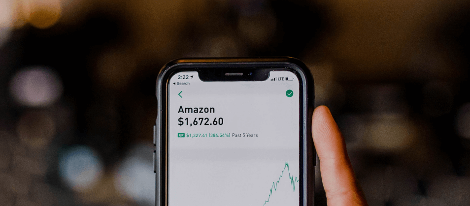 A phone displaying amazons stock value - An Overview of Credit Karma and Credit Sesame