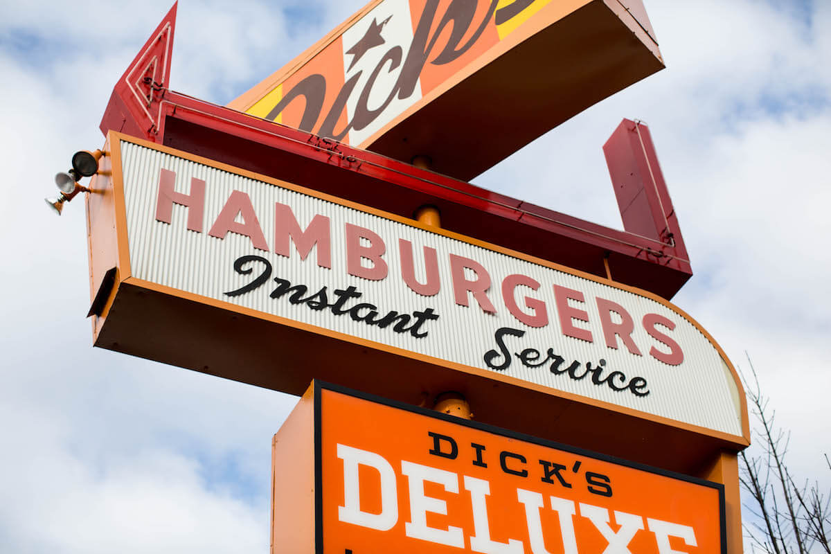 A sign of Dicks Hamburger restaurant - Half a Century at the Drive-In